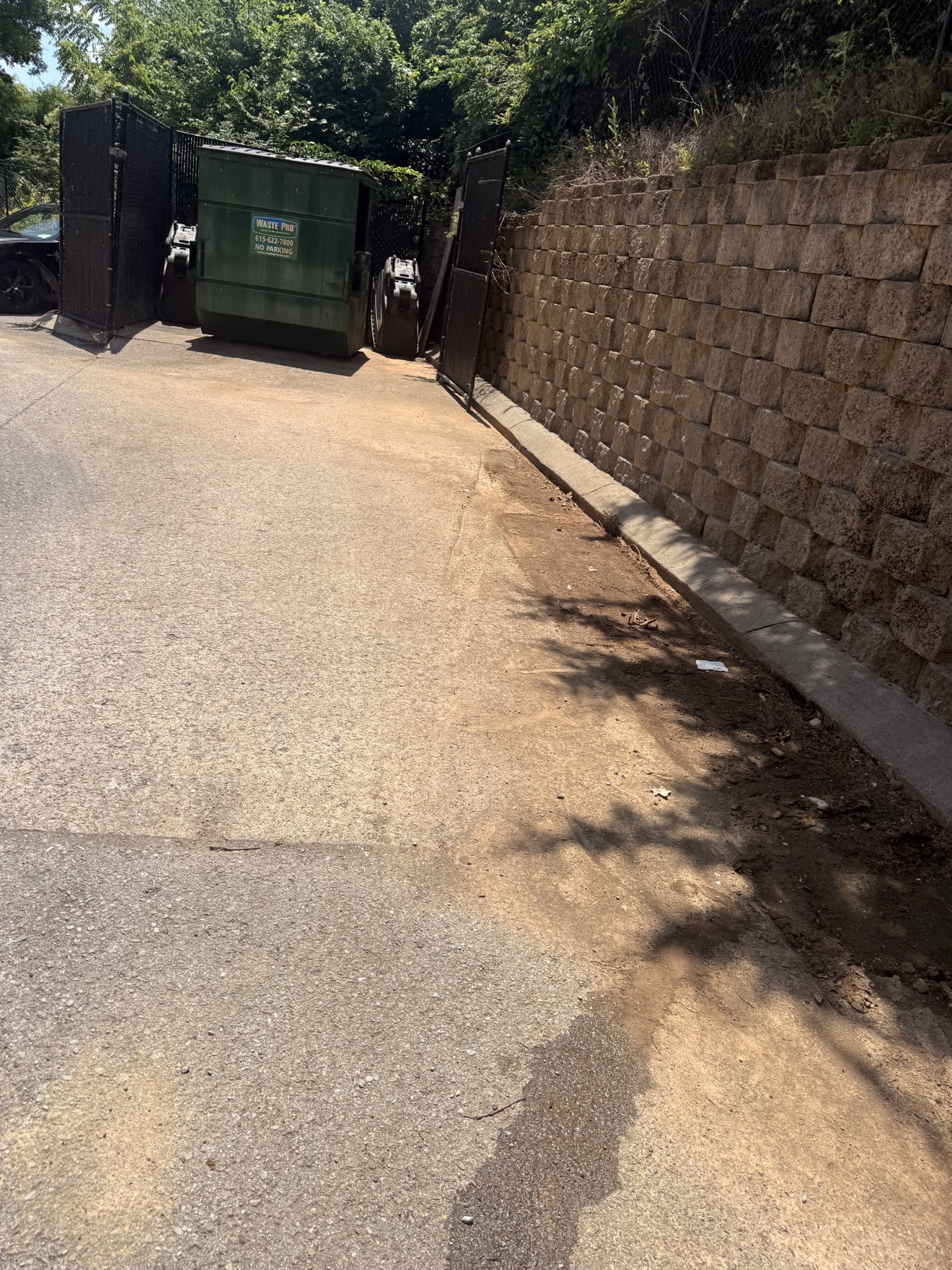 After: the retaining wall area completely cleared of furniture and appliances